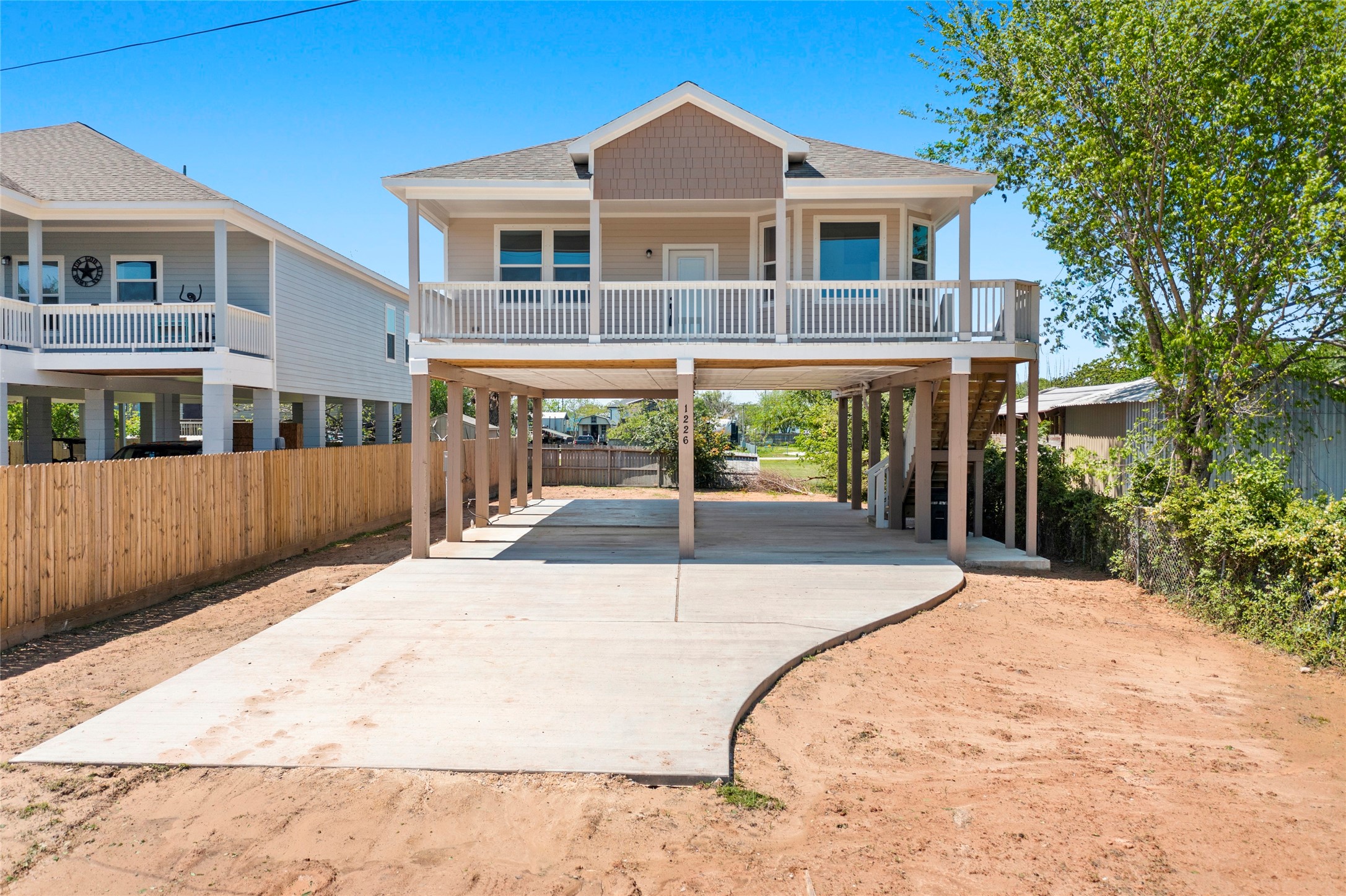 1226 9th Street San Leon, TX 77539 - Photo 3 of 32 a front view of a house with a yard