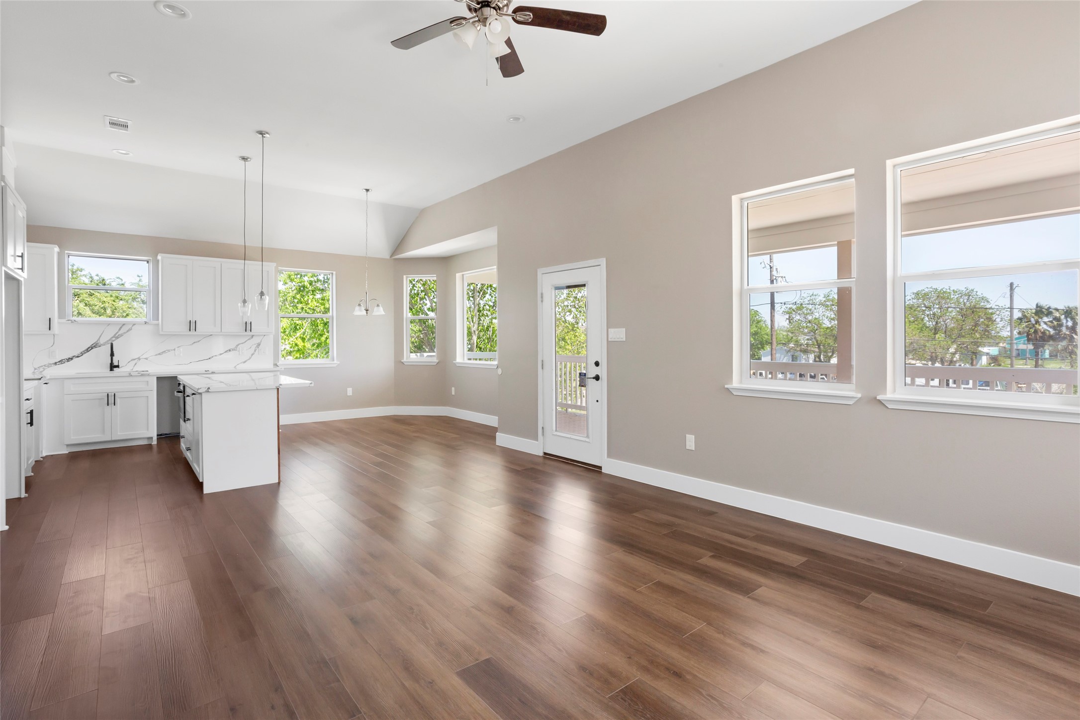 1226 9th Street San Leon, TX 77539 - Photo 10 of 32 a view of an empty room with a window and wooden floor