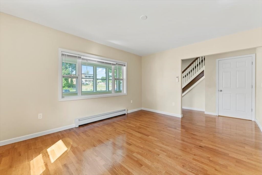 39 Milton Street Springfield, MA 01151 - Photo 8 of 30 an empty room with wooden floor and windows