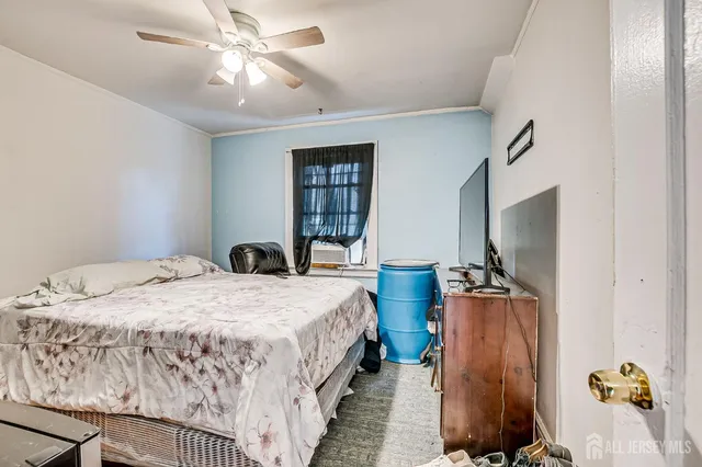 a bed room with a bed and a television