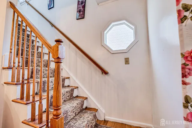 a view of staircase with railing and a potted plants