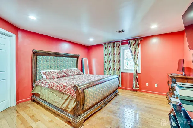 a bed sitting in a room next to a window