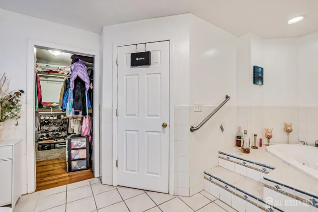 a bedroom with bed and wooden floor