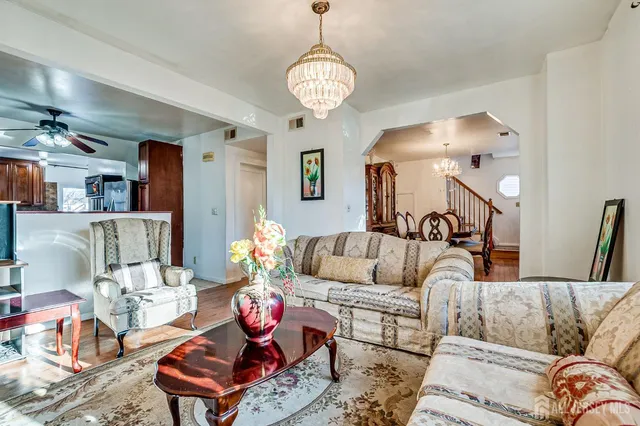 a living room with furniture and a chandelier