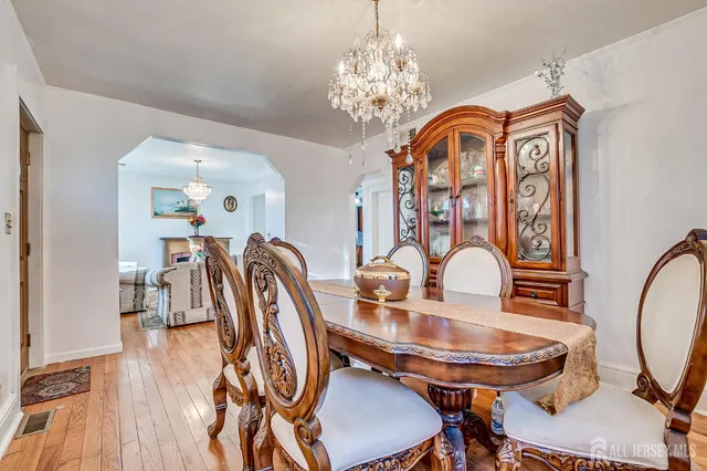 a view of a dining room with furniture wooden floor and chandelier