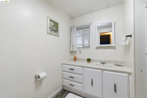 a view of a closet area with wooden floor