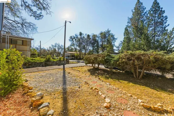 a view of a street with wooden fence