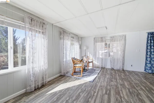 a view of a room with furniture and wooden floor