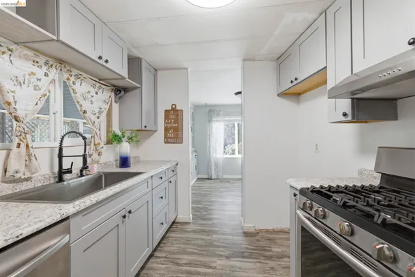 a kitchen with stainless steel appliances granite countertop a sink and a stove