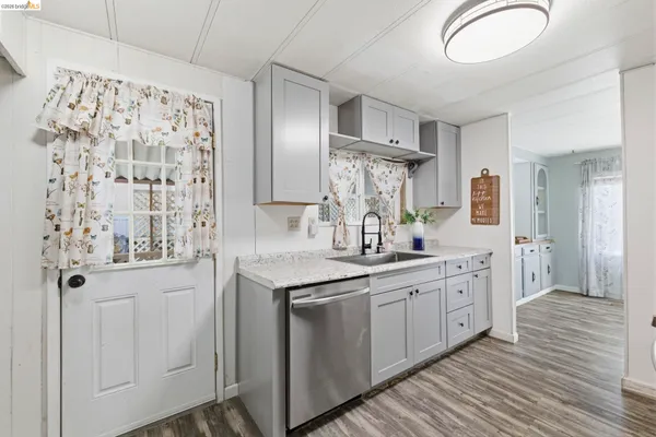 a kitchen with stainless steel appliances a sink and a refrigerator