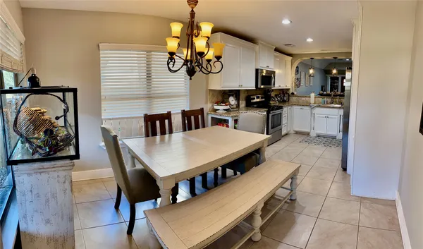 a kitchen with stainless steel appliances kitchen island granite countertop a stove a sink a refrigerator and a microwave