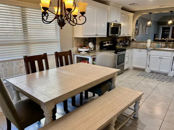 a kitchen with a table chairs and a stove