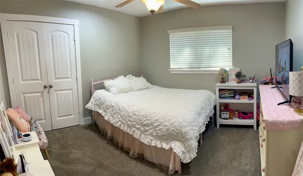 a bedroom with a bed and a window