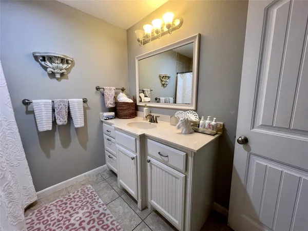 a bathroom with a sink toilet and mirror
