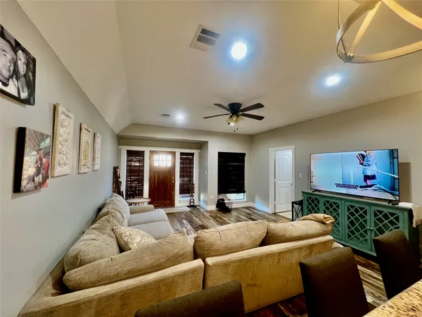 a living room with furniture and a flat screen tv