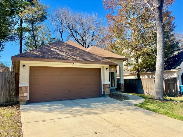 a view of house with backyard and trees