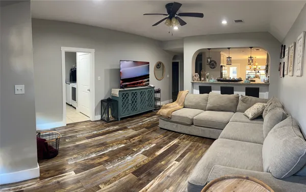 a living room with furniture a large window and a flat screen tv