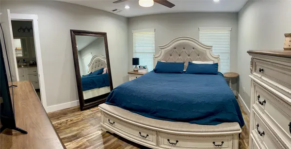 a bedroom with a bed and a mirror