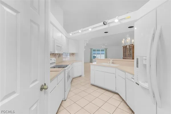 a large white kitchen with a sink