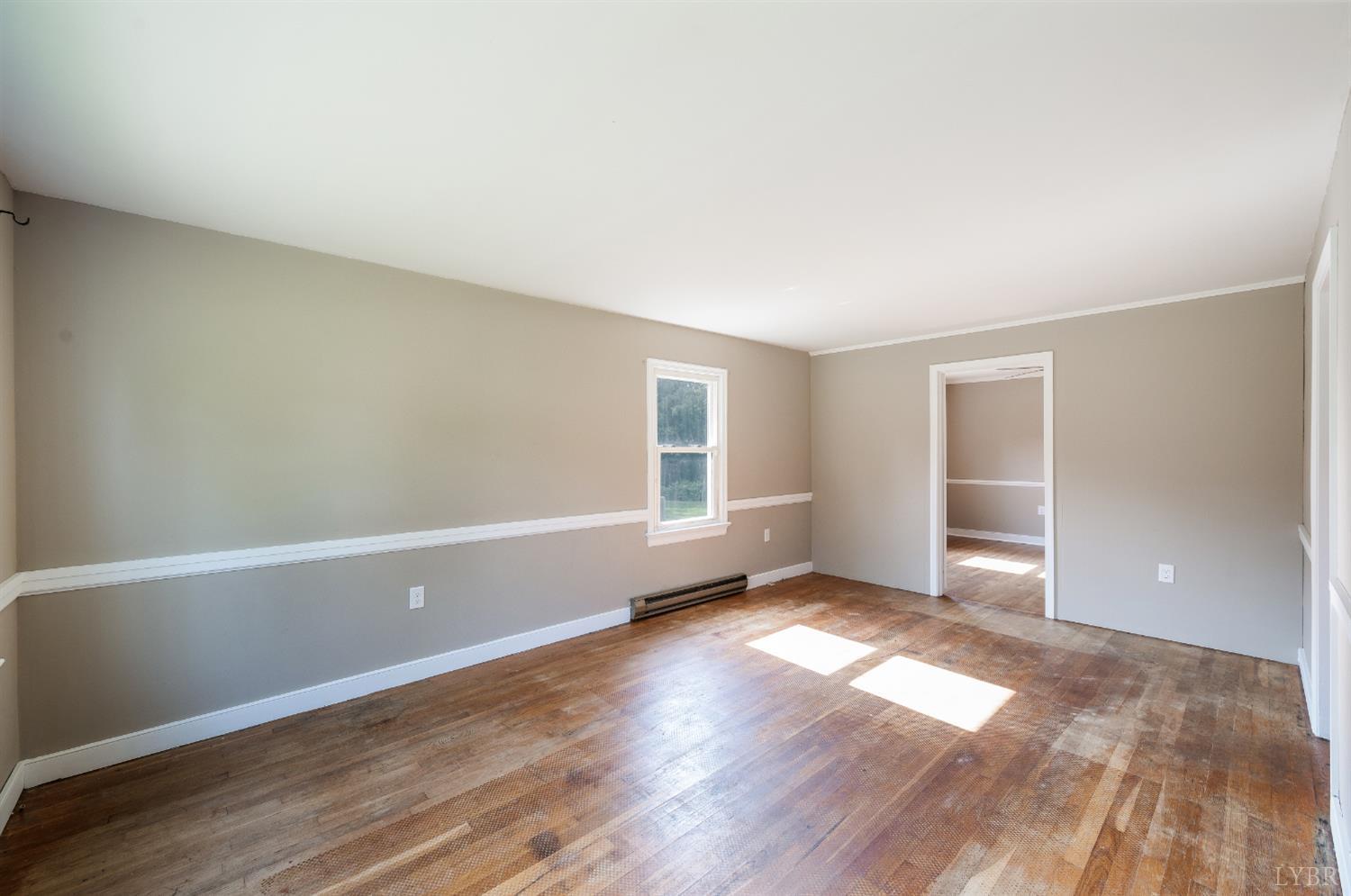4550 Pumping Station Road Appomattox, VA 24522 - Photo 14 of 34 an empty room with wooden floor and windows