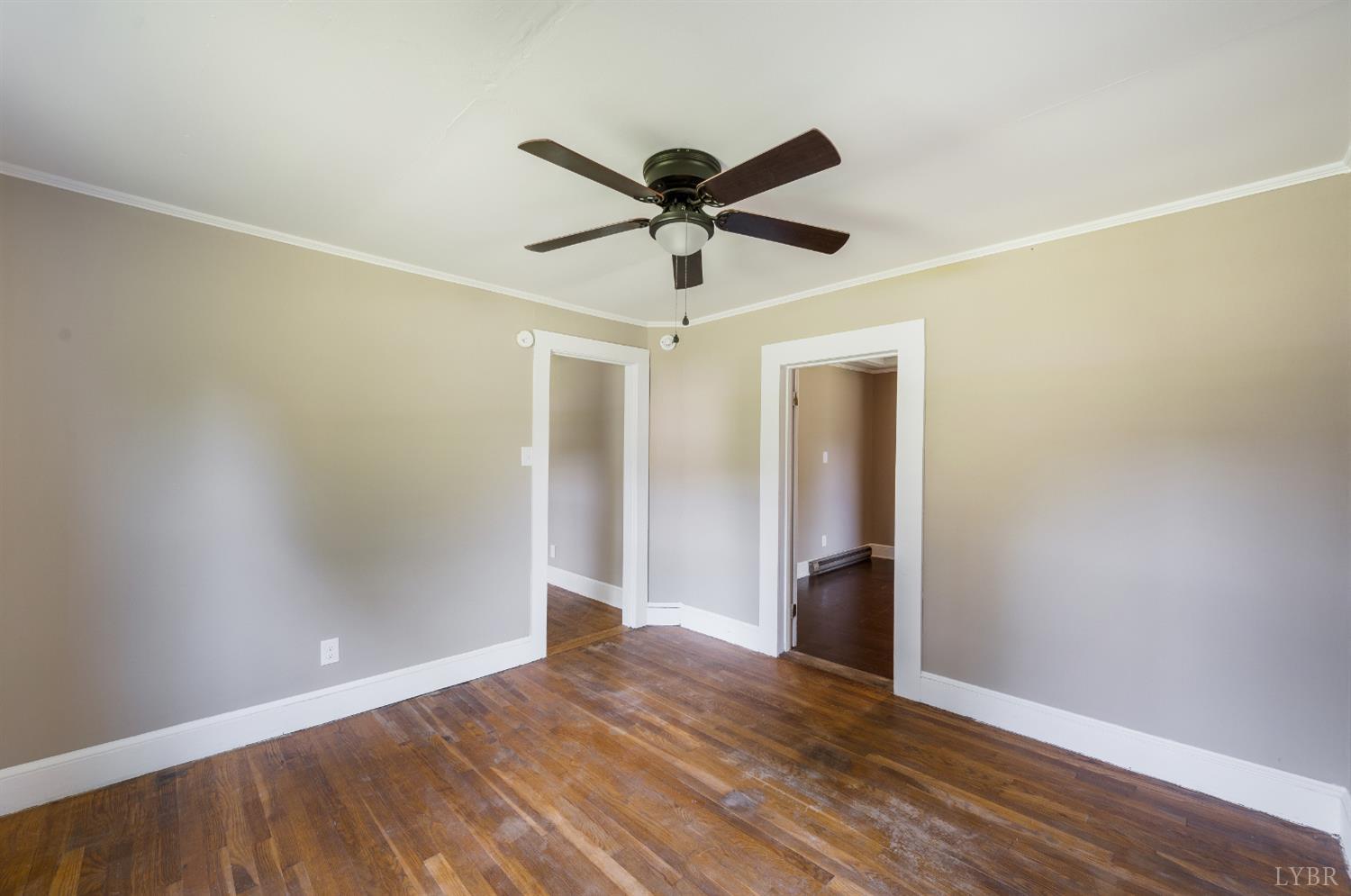 4550 Pumping Station Road Appomattox, VA 24522 - Photo 20 of 34 a view of a big room with wooden floor and a ceiling fan