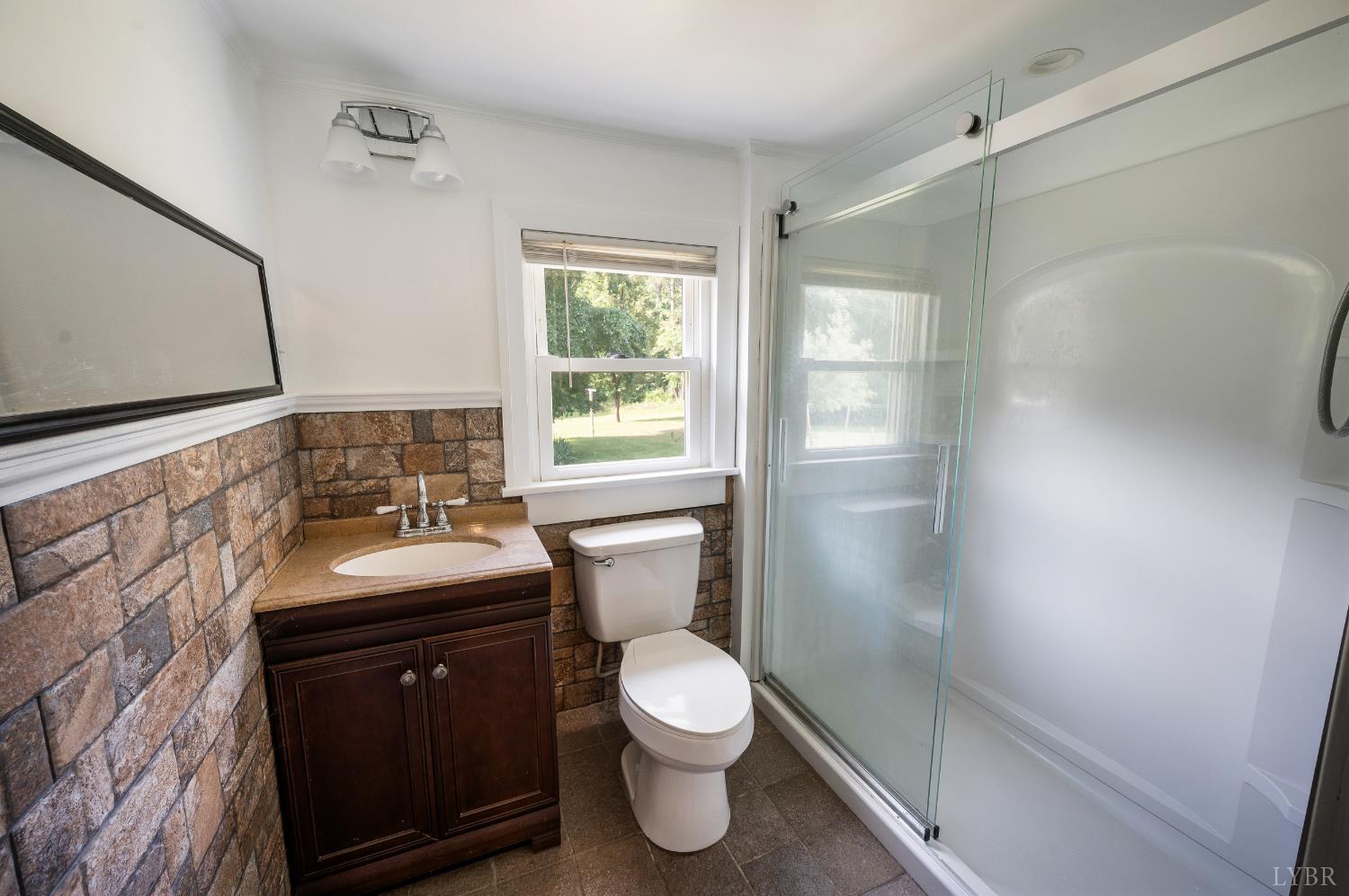 4550 Pumping Station Road Appomattox, VA 24522 - Photo 22 of 34 a bathroom with a sink a toilet and shower