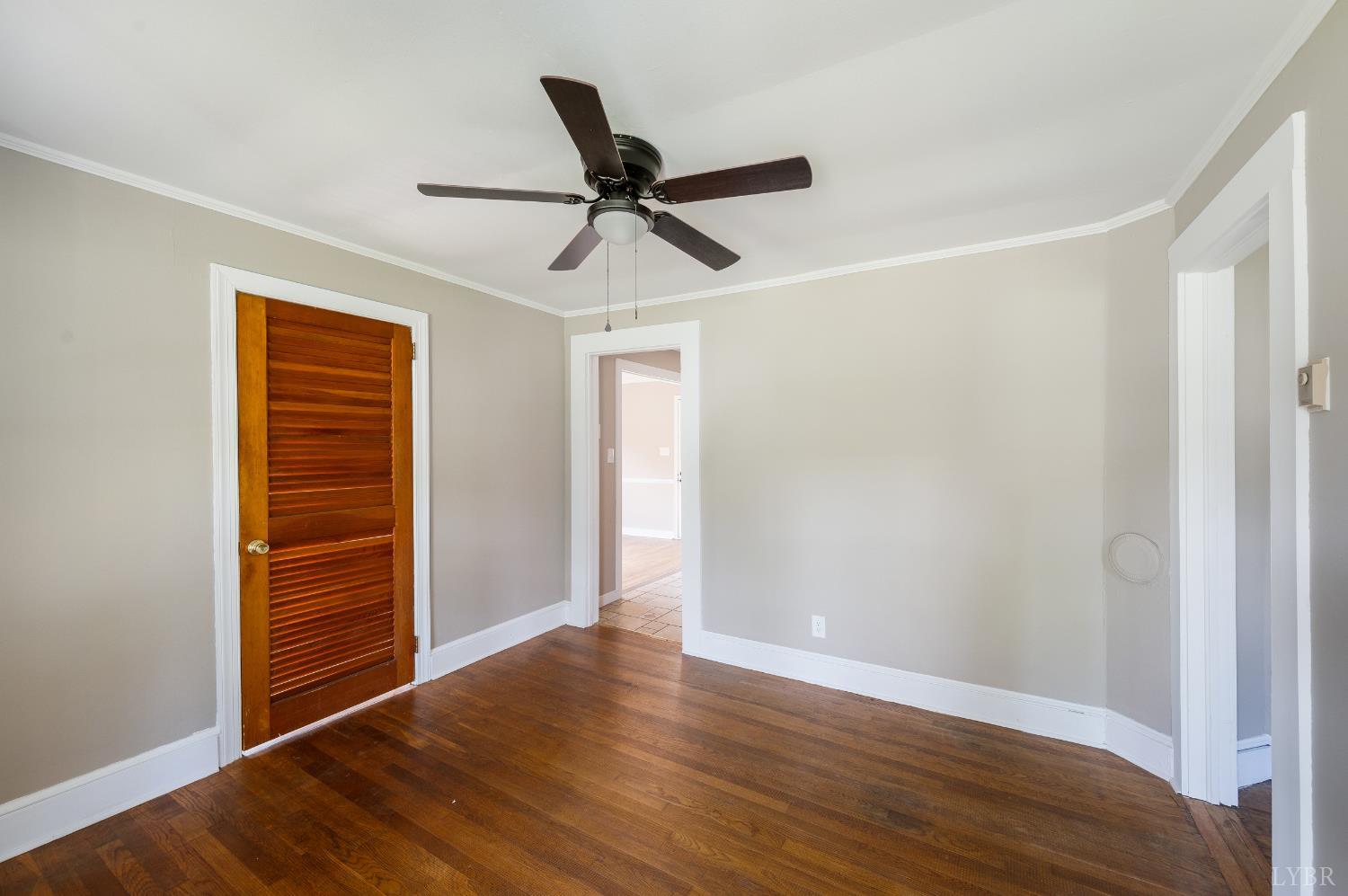 4550 Pumping Station Road Appomattox, VA 24522 - Photo 4 of 34 a view of a livingroom with wooden floor and a ceiling fan