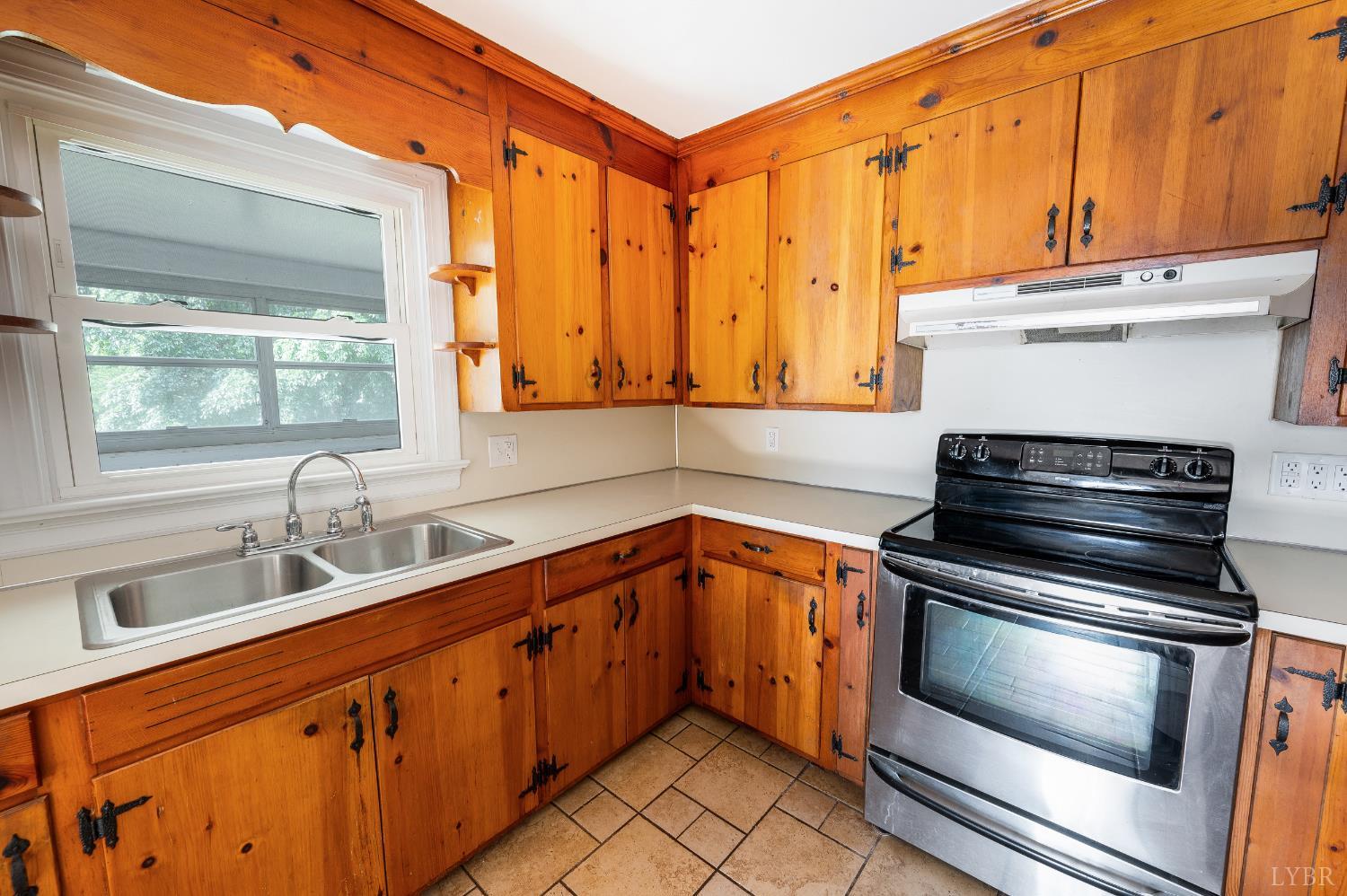 4550 Pumping Station Road Appomattox, VA 24522 - Photo 7 of 34 a kitchen with stainless steel appliances a stove sink and cabinets