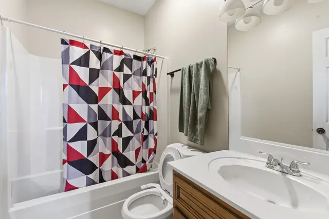 a bathroom with a sink and a shower curtain
