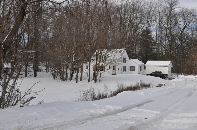 a view of a house with a snow in the yard