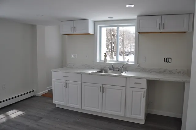 a kitchen with a sink cabinets and window