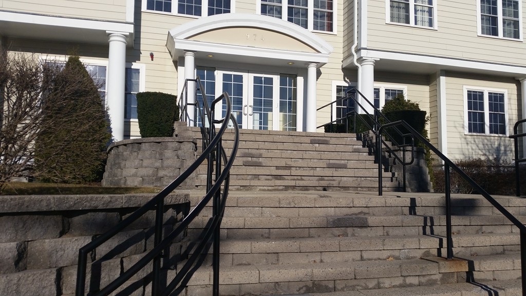 974 Main Street, Unit 25 Wakefield, MA 01880 - Photo 21 of 28 a front view of a house with a porch