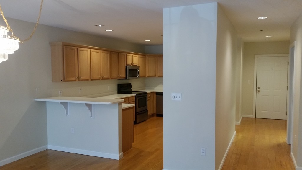 974 Main Street, Unit 25 Wakefield, MA 01880 - Photo 4 of 28 a kitchen with a refrigerator and a sink