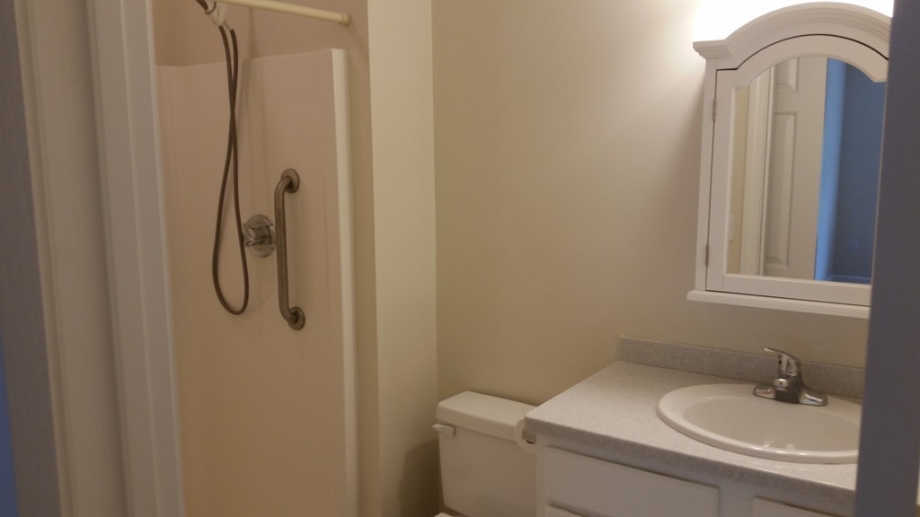 974 Main Street, Unit 25 Wakefield, MA 01880 - Photo 8 of 28 a bathroom with a granite countertop sink toilet and shower