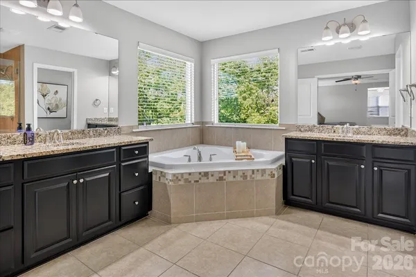 a bathroom with a granite countertop sink and a toilet