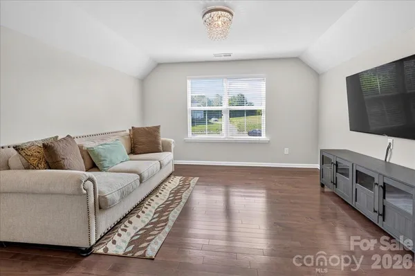 a living room with window and a flat screen tv
