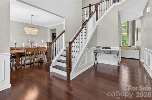a kitchen with a table chairs refrigerator and cabinets