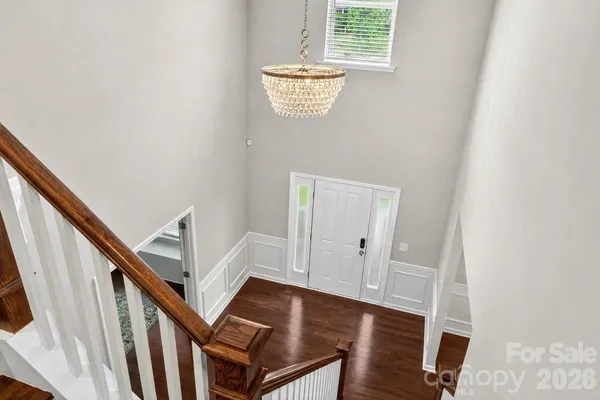 a kitchen with stainless steel appliances a dining table chairs stove refrigerator and cabinets
