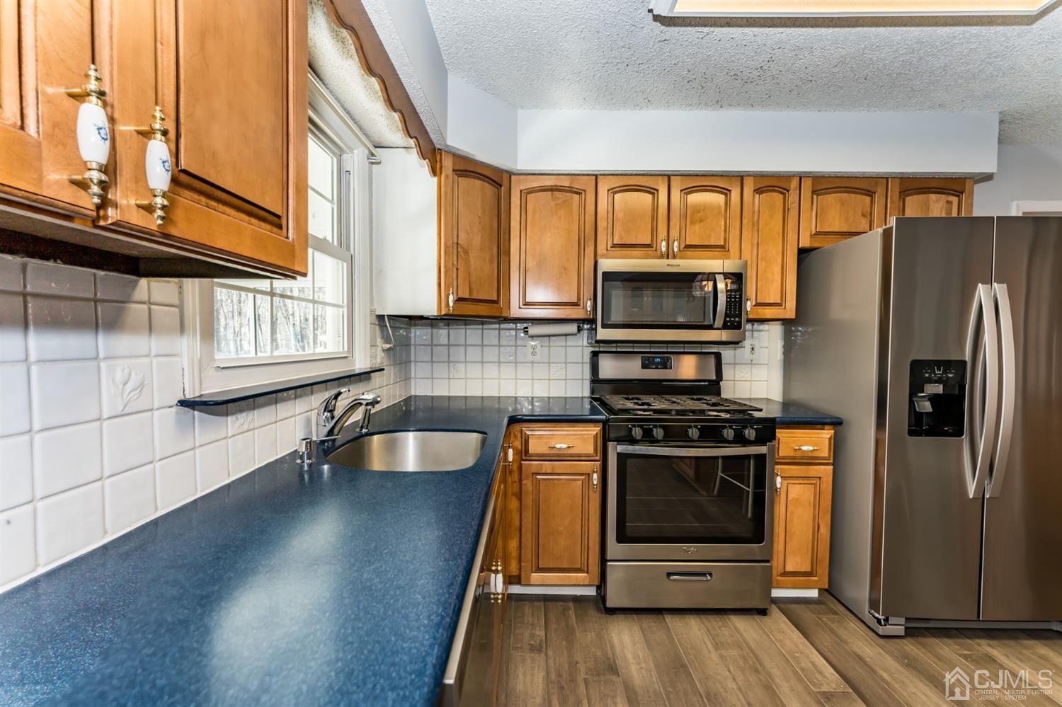 7 Brotherton Road Shamong, NJ 08088 - Photo 14 of 45 a kitchen with granite countertop a stove and a refrigerator
