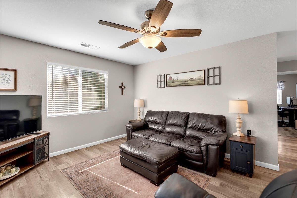 2110 Gentry Way Red Bluff, CA 96080 - Photo 7 of 47 a living room with furniture and a flat screen tv