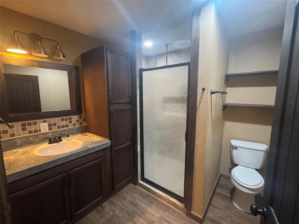 377 Private Road 3249, Unit ARENA Decatur, TX 76234 - Photo 34 of 40 a bathroom with a toilet sink and mirror