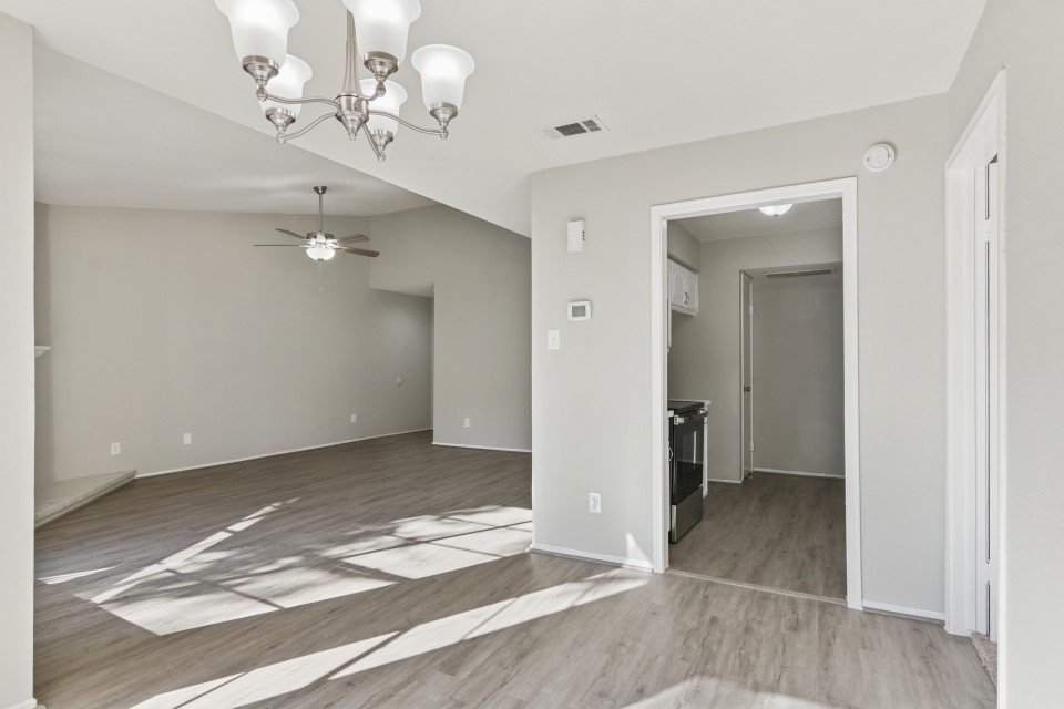 9707 Richmond Avenue, Unit 98 Houston, TX 77063 - Photo 12 of 24 wooden floor in an empty room with a mirror