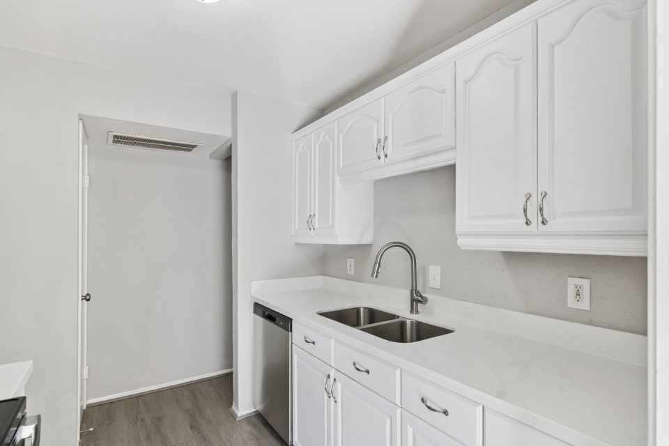 9707 Richmond Avenue, Unit 98 Houston, TX 77063 - Photo 14 of 24 a kitchen with white cabinets a sink and dishwasher