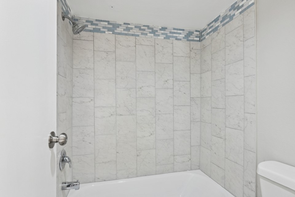 9707 Richmond Avenue, Unit 98 Houston, TX 77063 - Photo 21 of 24 a bathroom with a shower and a toilet