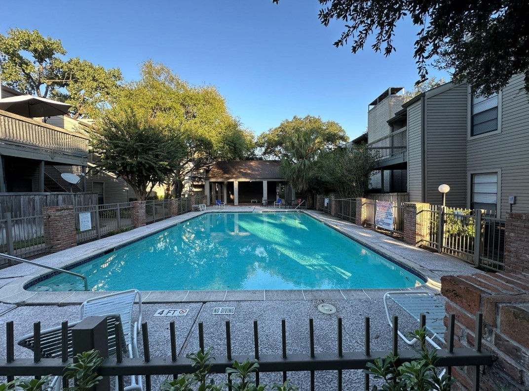 9707 Richmond Avenue, Unit 98 Houston, TX 77063 - Photo 24 of 24 a backyard with table and chairs and potted plants