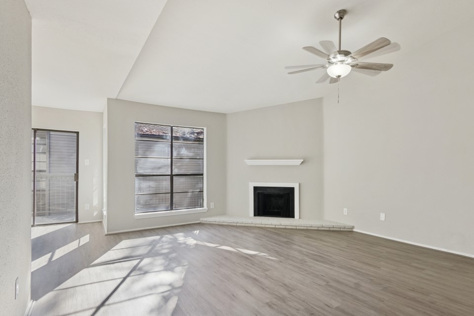 9707 Richmond Avenue, Unit 98 Houston, TX 77063 - Photo 5 of 24 a view of an empty room with a fireplace and a window