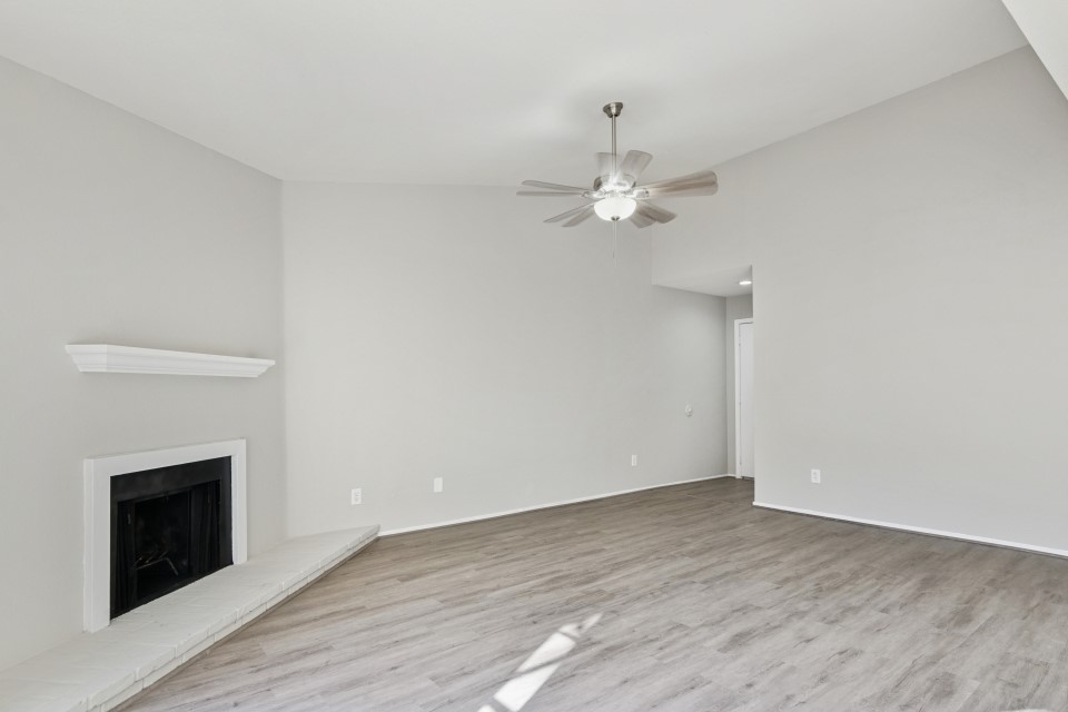 9707 Richmond Avenue, Unit 98 Houston, TX 77063 - Photo 6 of 24 wooden floor in an empty room with a fireplace