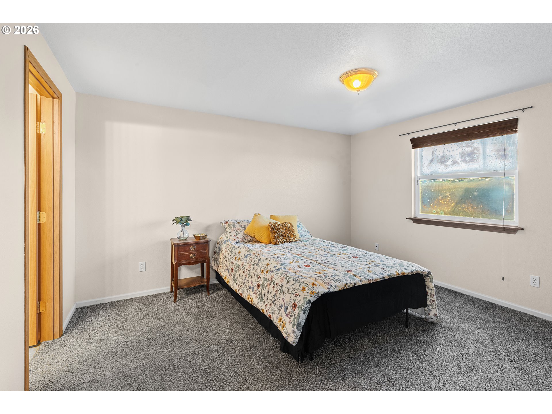 1314 Southwest 11th Court Pendleton, OR 97801 - Photo 12 of 30 a bedroom with a bed and a window