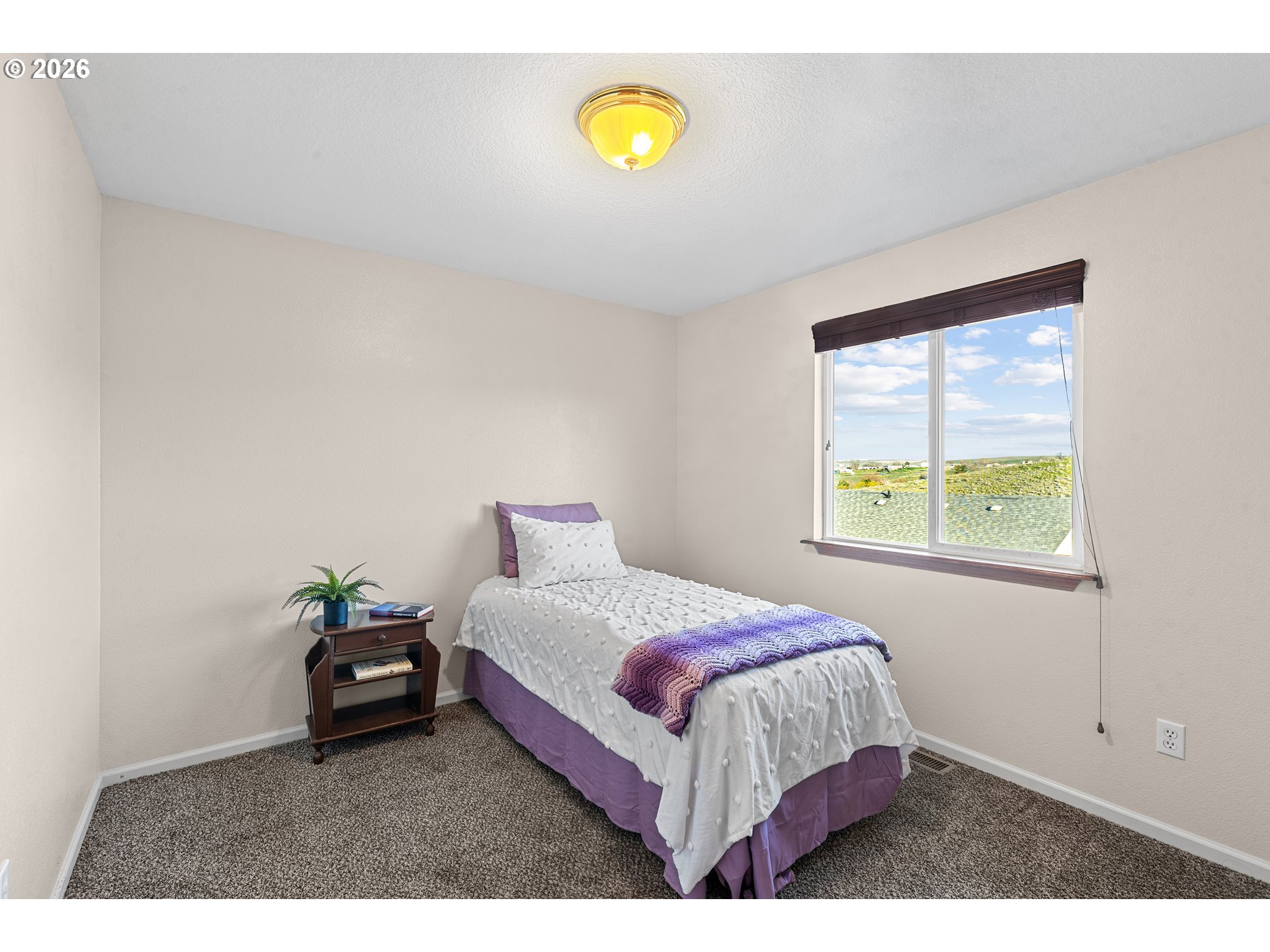 1314 Southwest 11th Court Pendleton, OR 97801 - Photo 18 of 30 a bedroom with a bed and a window
