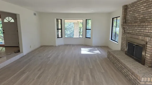a living room with furniture fireplace and flat screen tv
